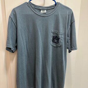 This is a blue pocket t-shirt with an Auburn University logo on the pocket
